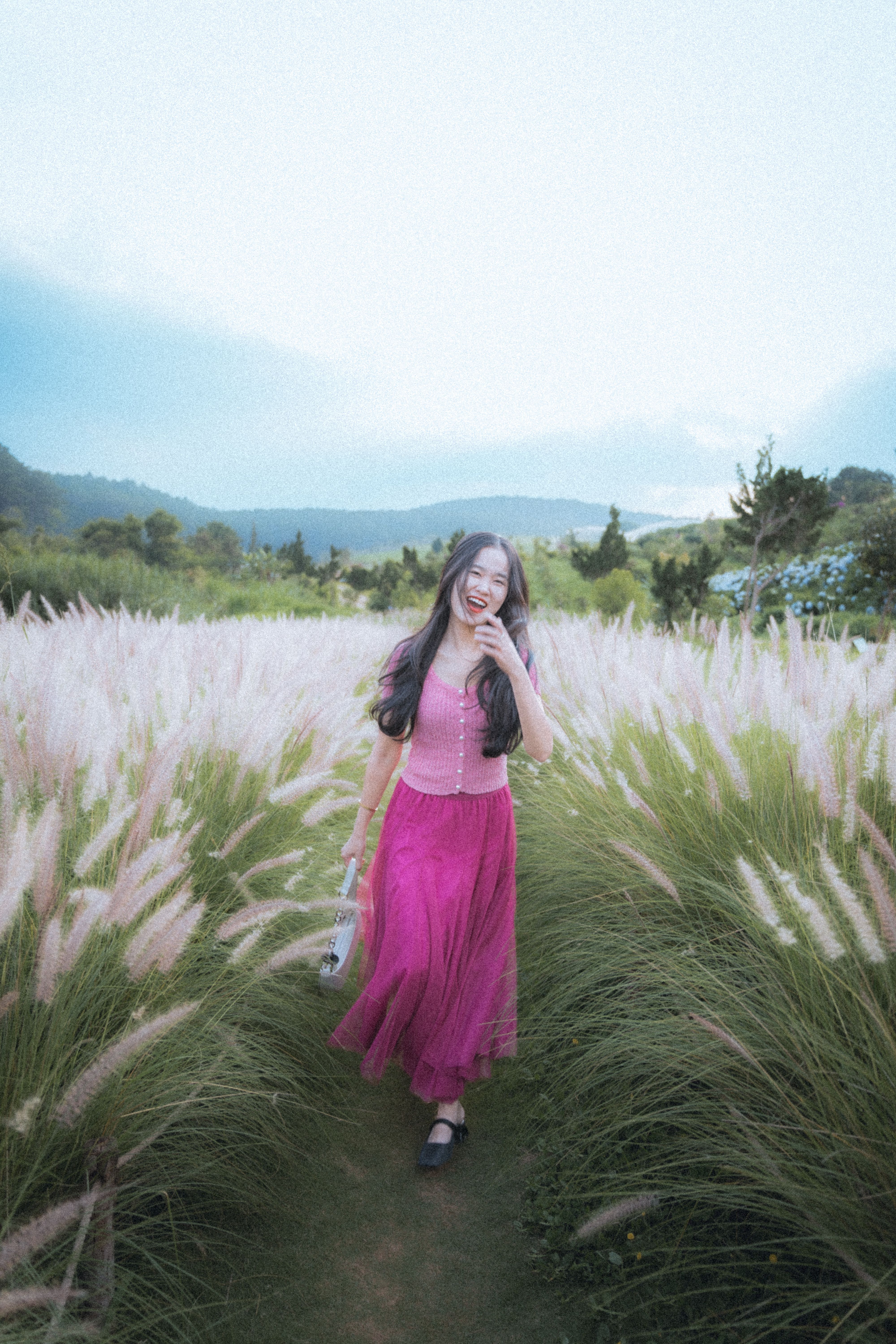 [ColoSach]-asian-woman-laughing-and-walking-through-a-vibrant-field-in-dalat,-vietnam.