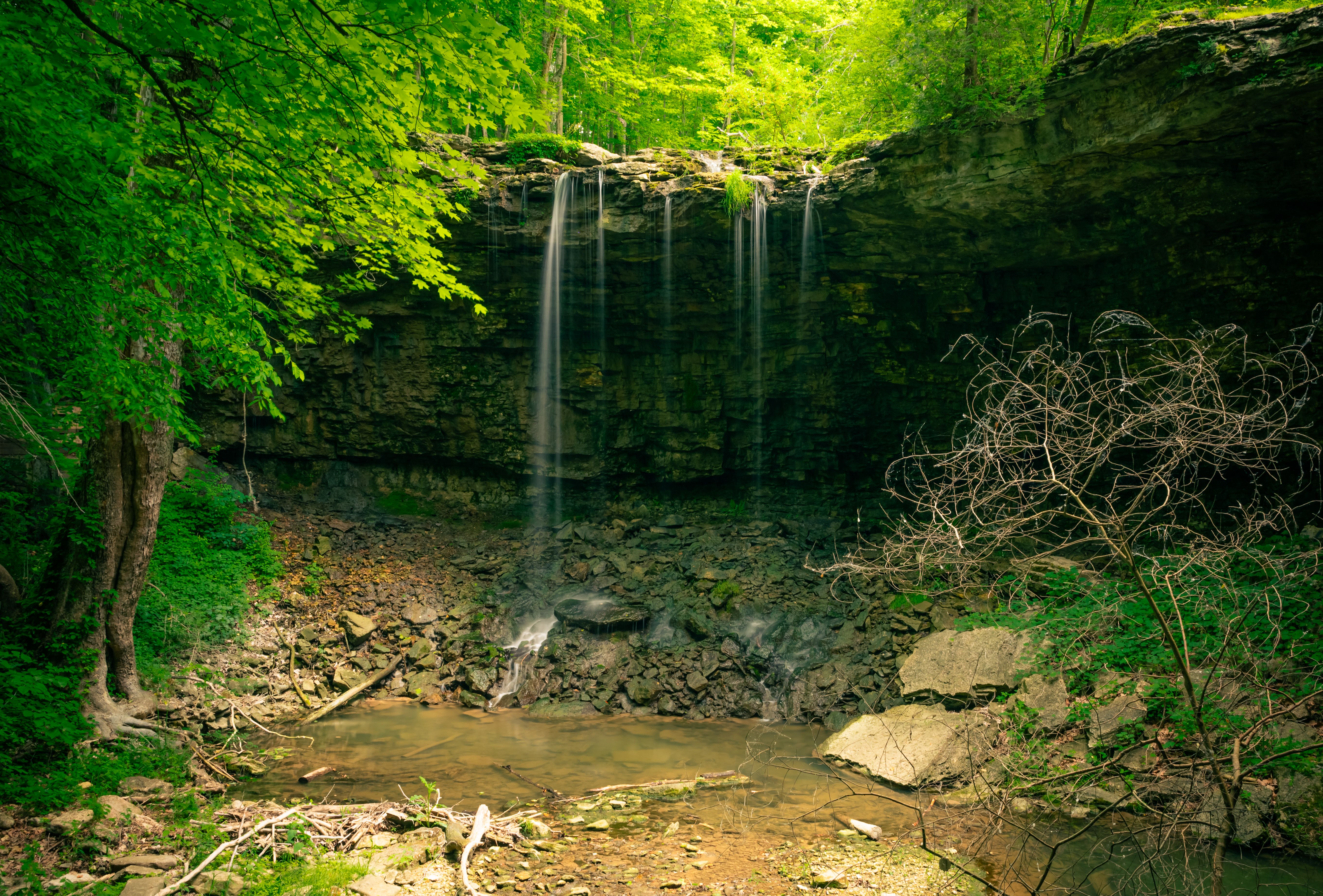 Water Flowing from Stone Shelf into Cavern · Free Stock Photo