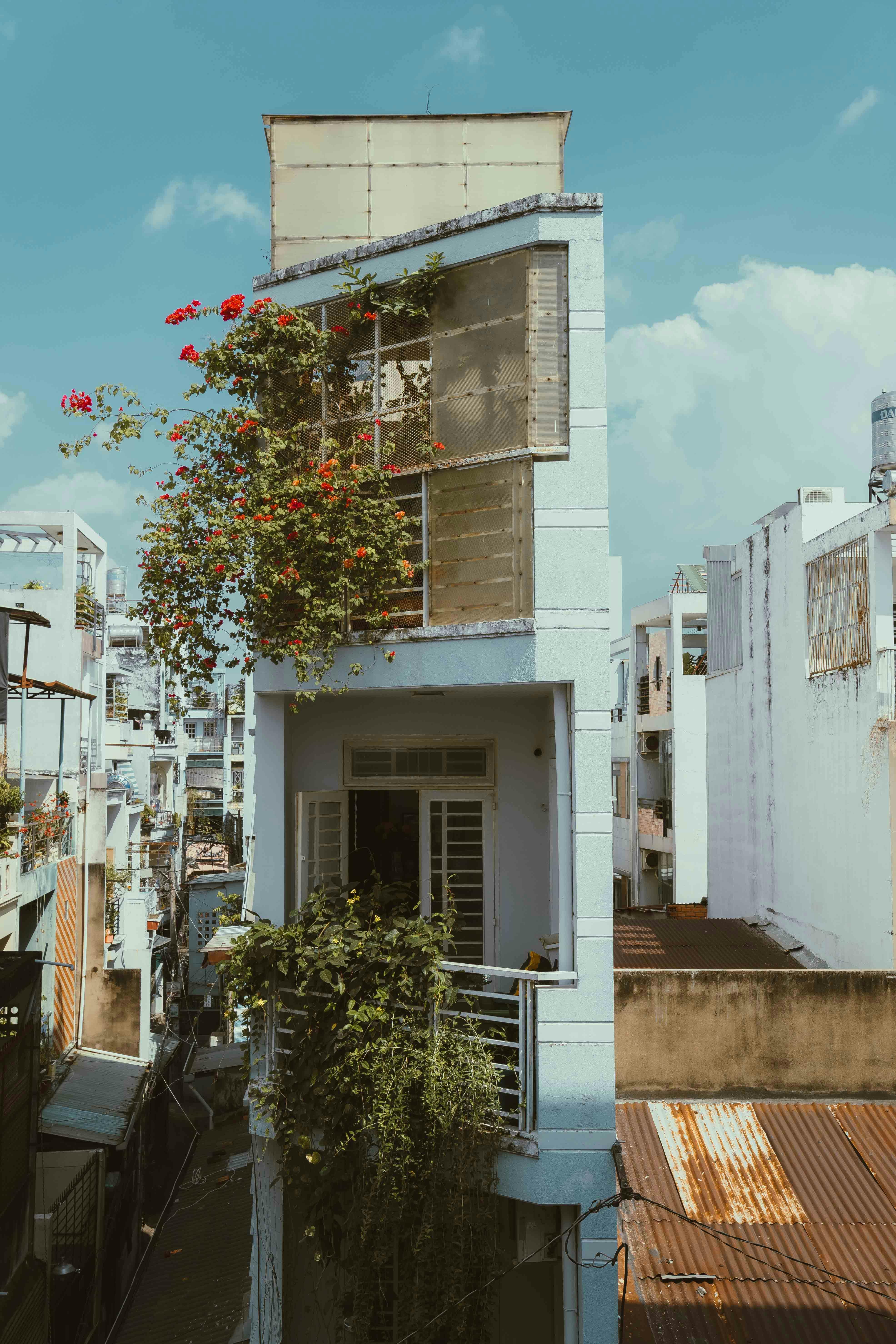 Explore a vertical architectural gem with lush plants in Ho Chi Minh City's urban landscape.