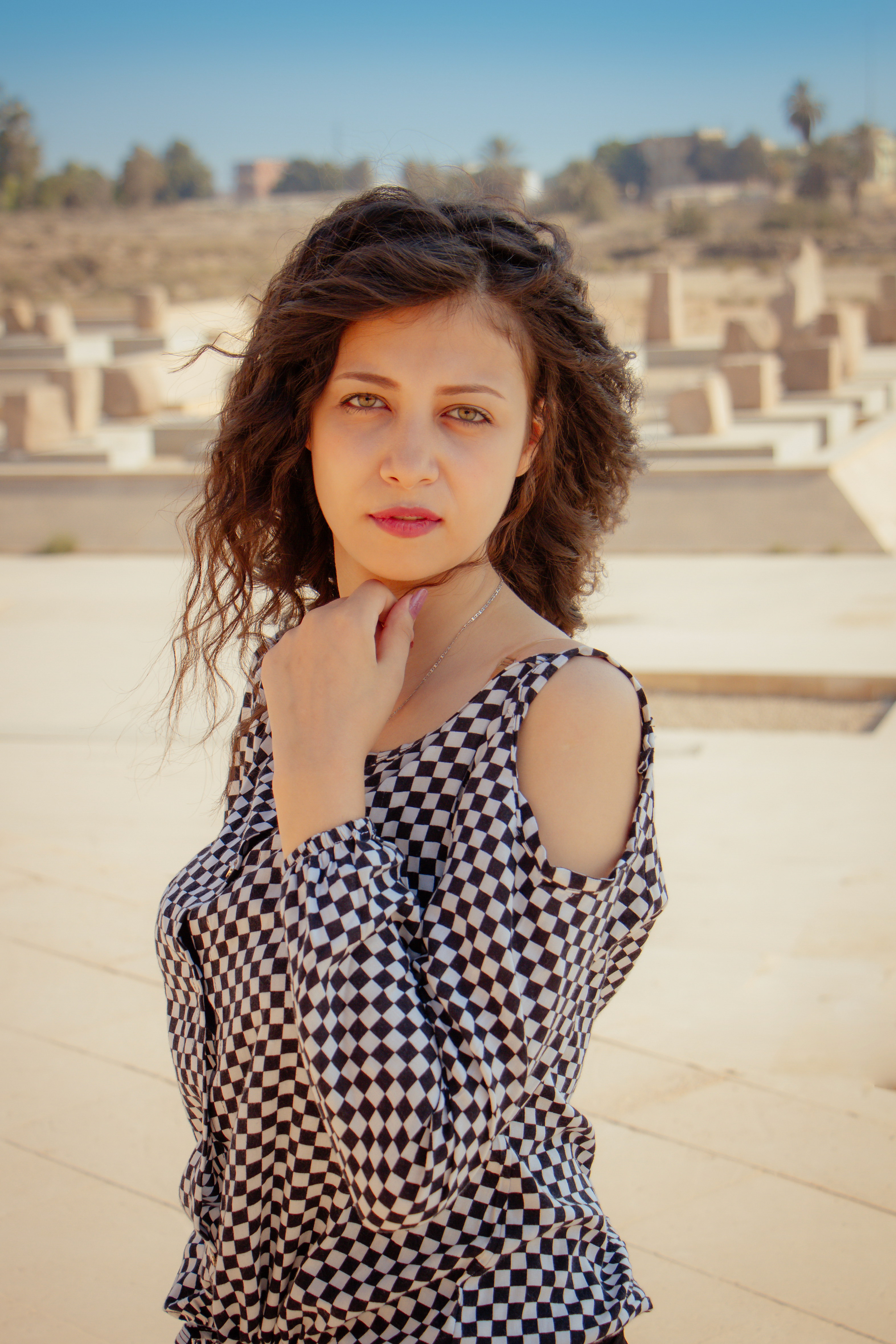 Stylish portrait of a woman in a checkered dress outdoors in Cairo.