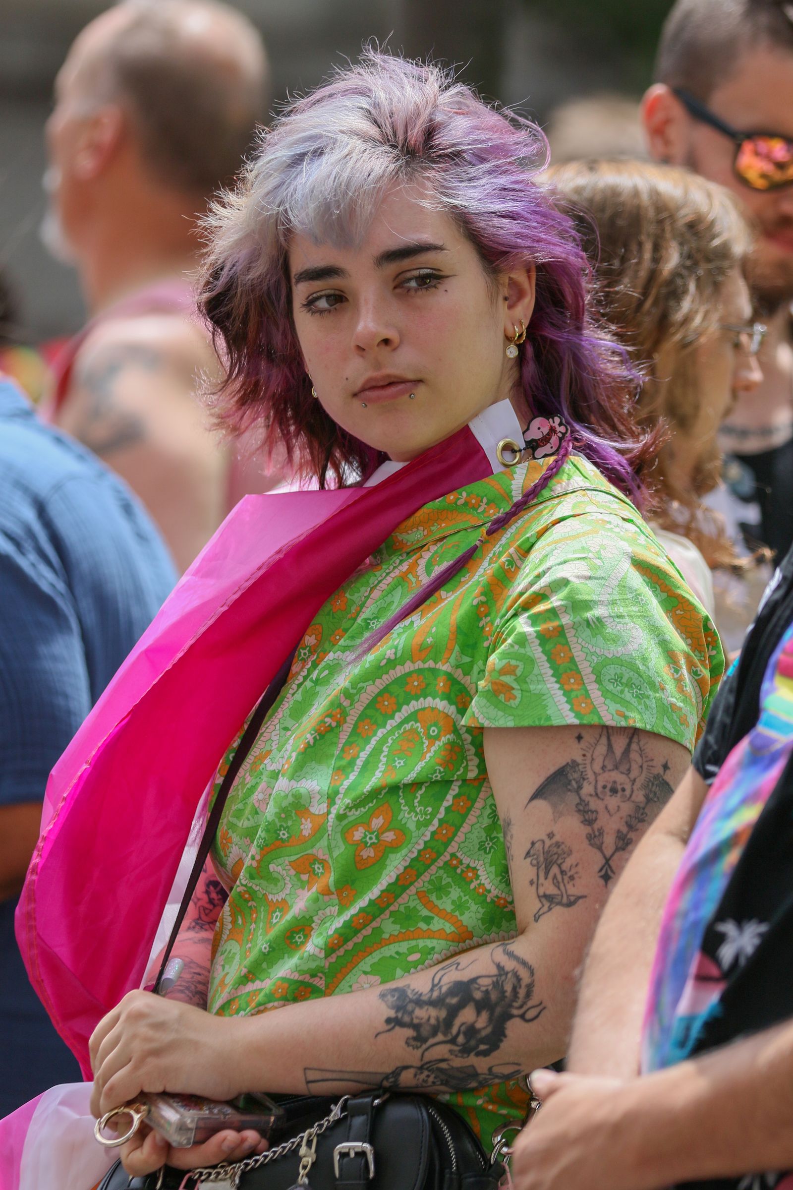 A wheelchair user smiling at a public outdoor event.