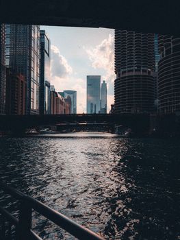 Dramatic Chicago skyline reflected in the river at dusk, showcasing modern architecture.
