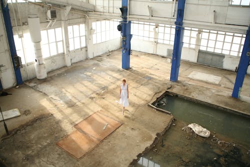 Woman Standing in White Building