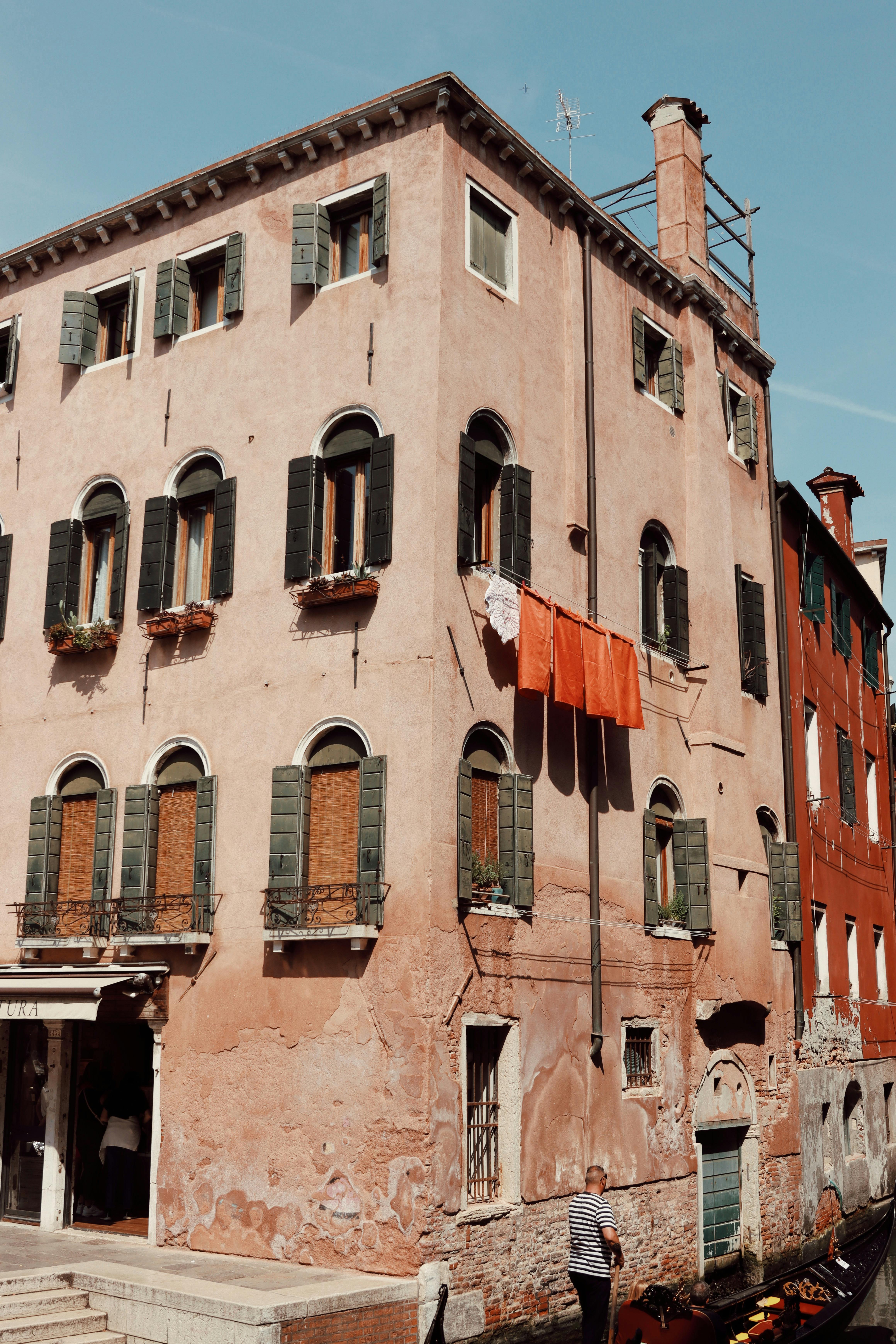 Charming Venetian building with traditional architecture and canal view. Perfect for travel and architecture themes.