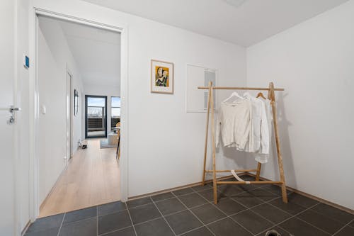 A room with a clothes rack and a door
