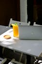 ProBook and a Glass of Orange Juice on a Table