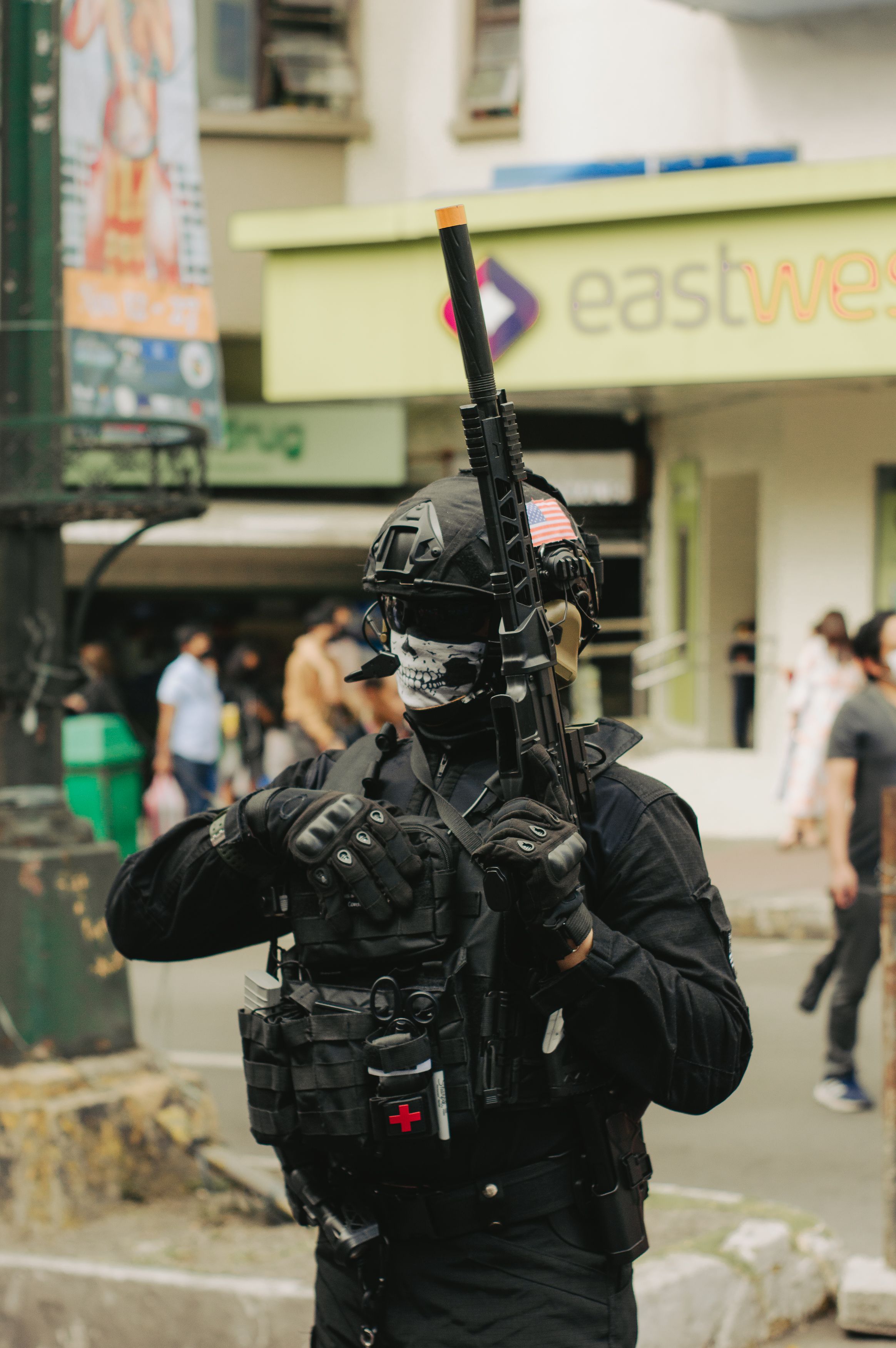A man in a black mask and helmet holding a gun · Free Stock Photo