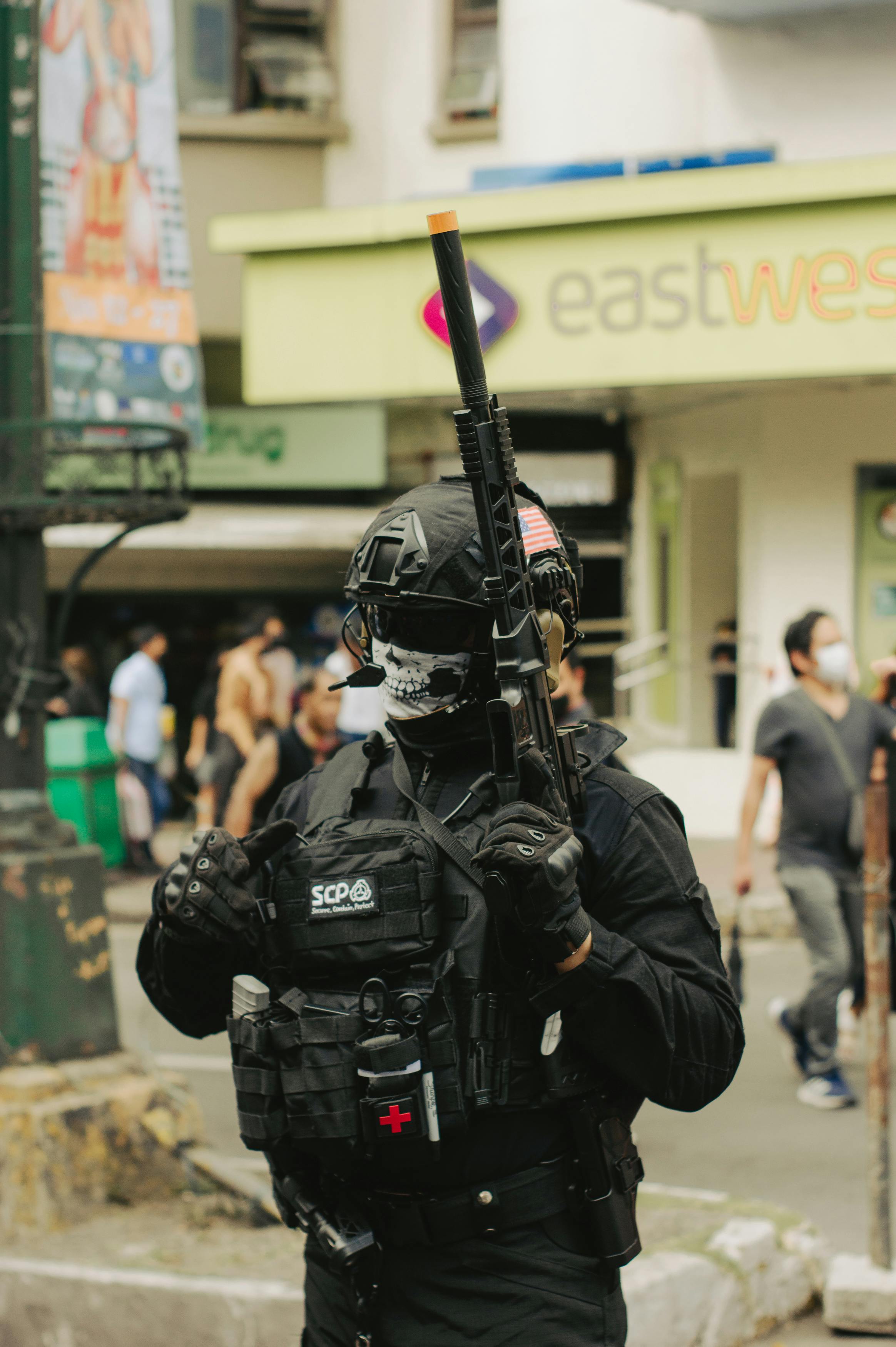 standing soldier in combat uniform standing in city