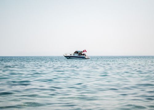Free A solitary yacht floats peacefully on the Aegean Sea near Özdere, creating a tranquil scene. Stock Photo