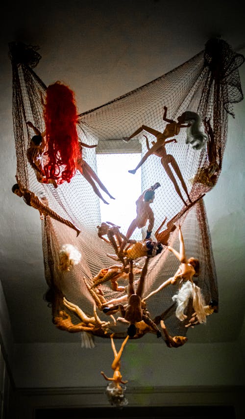 Dolls Hanging On A Net