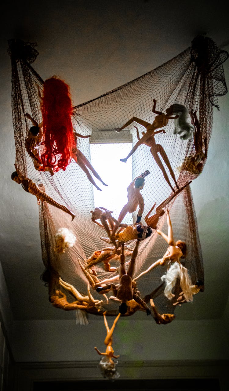 Dolls Hanging On A Net