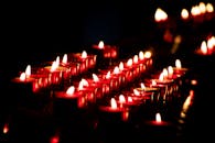 黑暗中，一缕缕发光的红色蜡烛营造出温暖、宁静的氛围