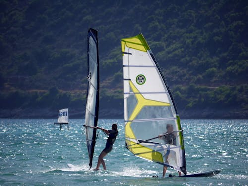Two People Windsurfing