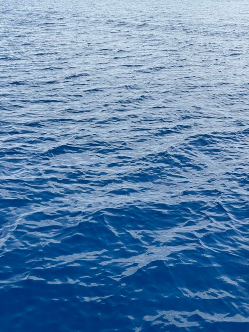 Free Tranquil surface of the Red Sea in Eilat with rippling blue waters under a clear sky. Stock Photo