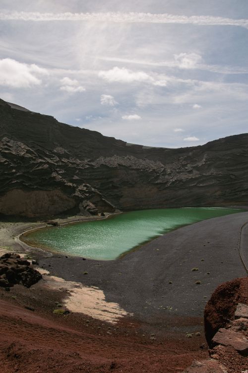 Free A breathtaking view of the green El Golfo Lagoon surrounded by volcanic terrain in Lanzarote. Stock Photo