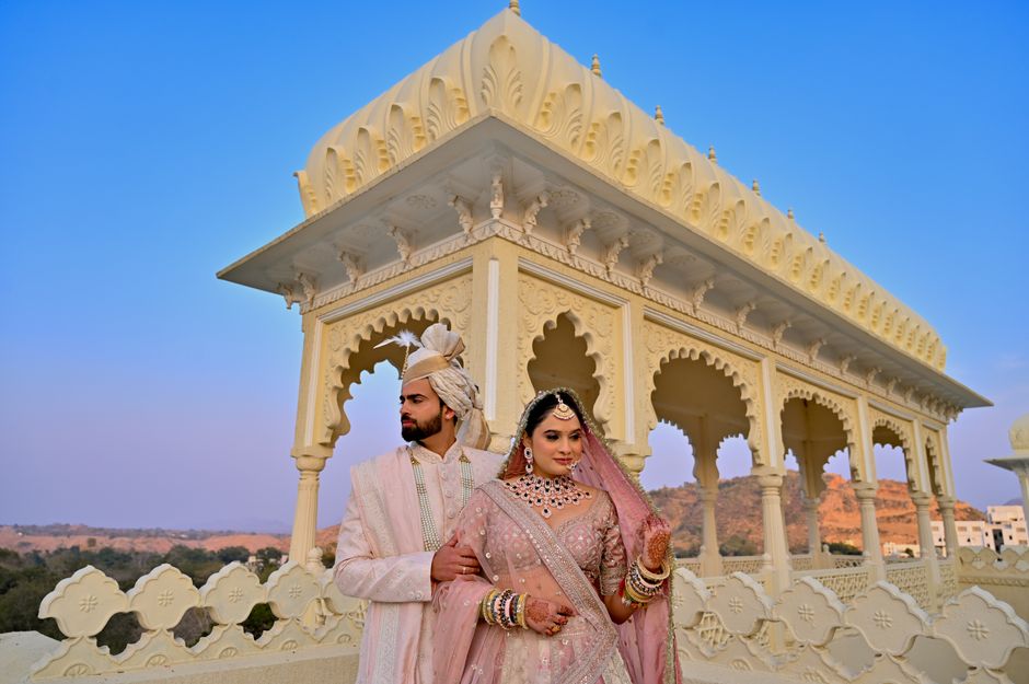 Beautiful couple posing for pre-wedding photoshoot at exotic destination with photographer