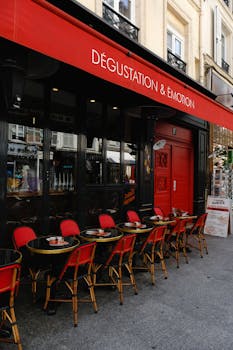 Paris café with red chairs and black tables, ideal for al fresco dining and experiencing French culture.