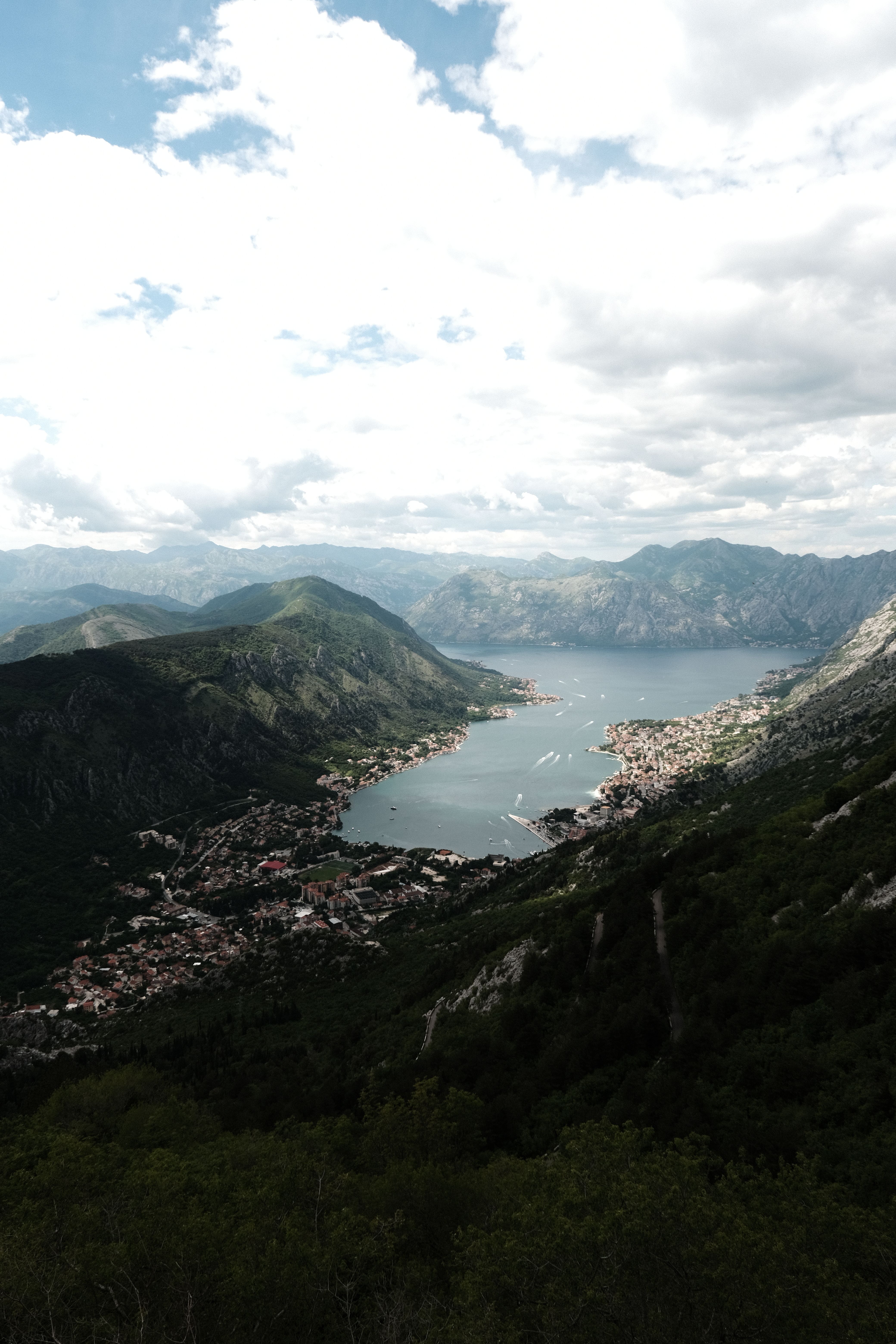 Stunning aerial view of the Bay of Kotor surrounded by lush mountains in Montenegro.