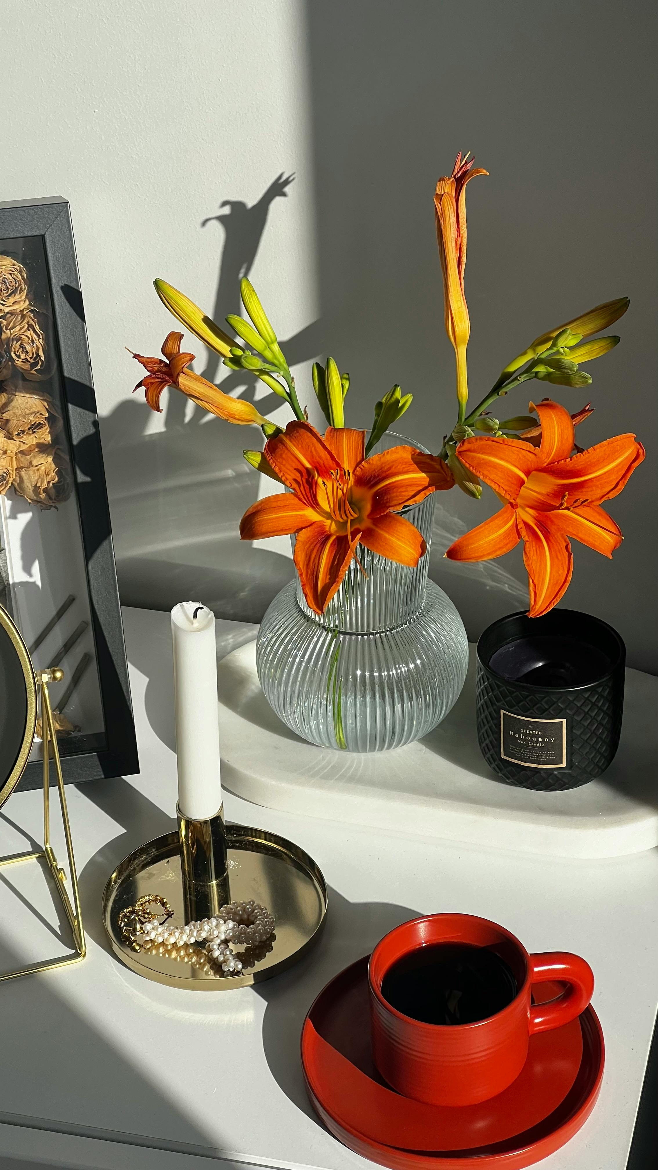 table with cup of coffee and vase of flowers