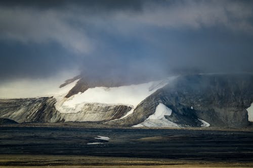 A snowy mountain range with a large glacier