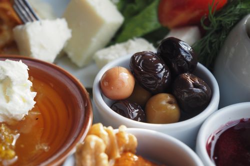 Free A close-up view of a Mediterranean breakfast with cheese, olives, and honey. Stock Photo