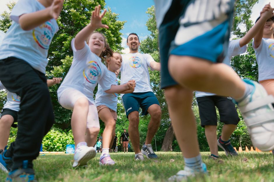 Photo by Aleksandar Andreev on Pexels Joyful group of children and adult engaging in playful activities in a sunny park setting. - Photo by Aleksandar Andreev on Pexels