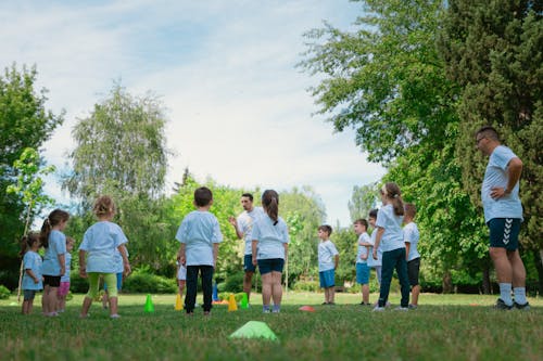 A group of children playing soccer in the grass