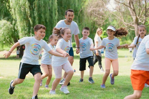 A group of children running in a park