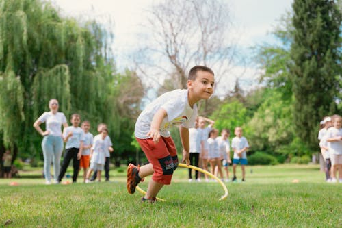 A young boy is playing with a hula hoop