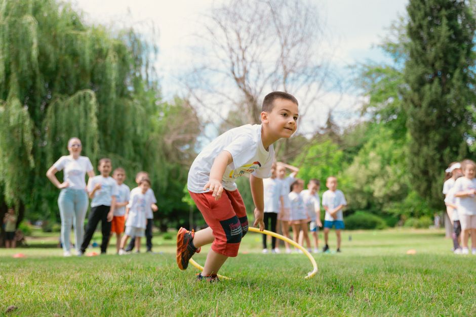 Kids enjoy outdoor fun with hula hoops in a vibrant park setting.