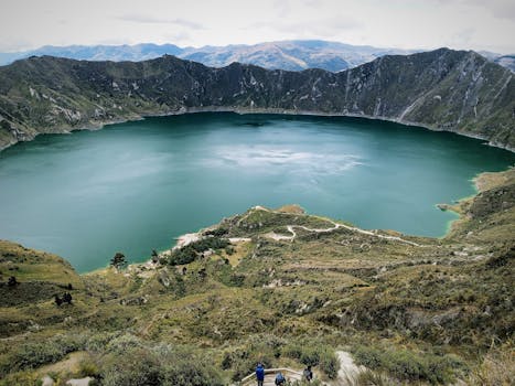 Breathtaking aerial view of Quilotoa crater lake surrounded by the majestic Andes mountains in Ecuador.