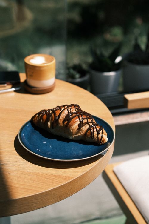 Free Delicious chocolate croissant and coffee in a cozy Istanbul cafe. Stock Photo
