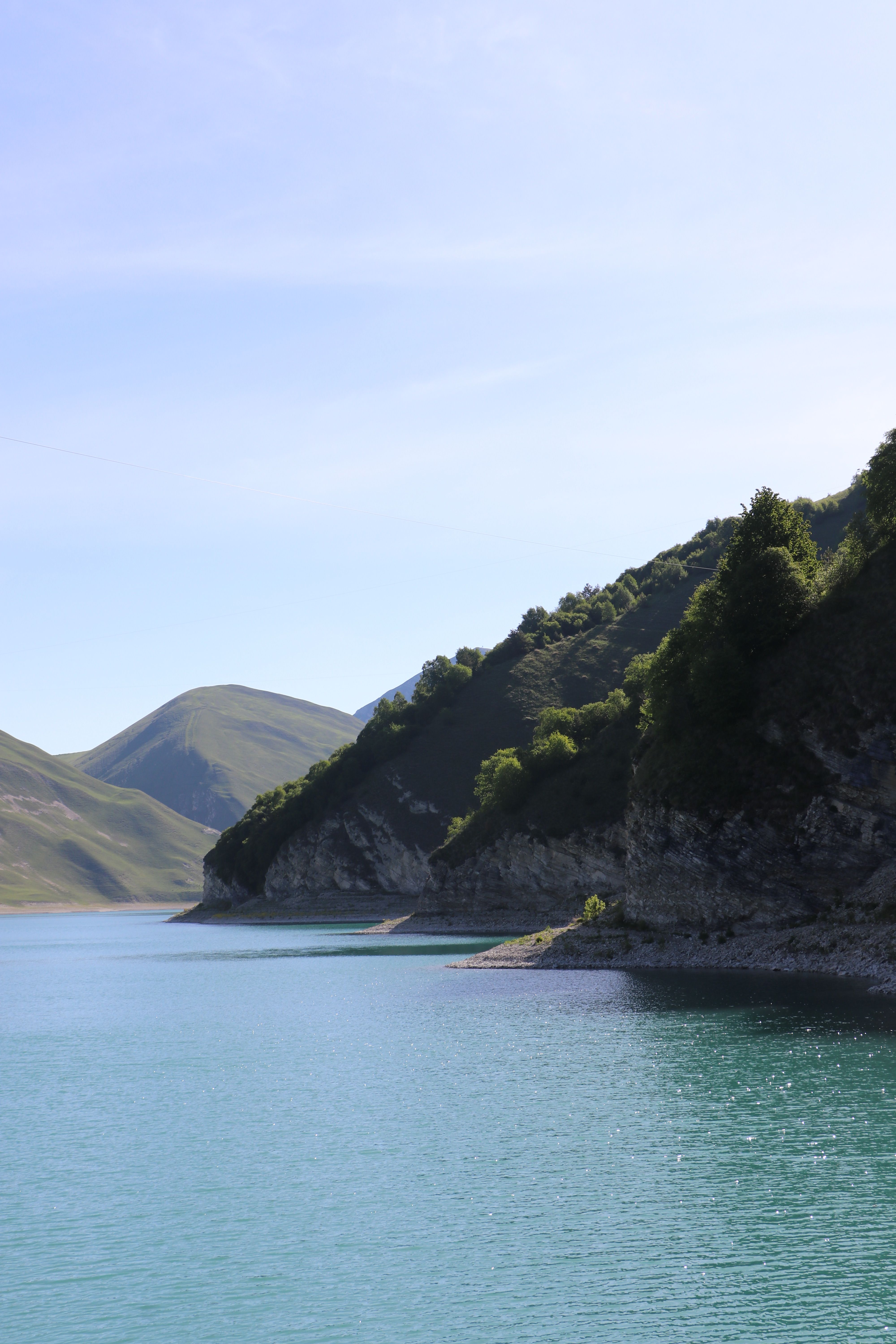 A body of water surrounded by mountains and trees · Free Stock Photo