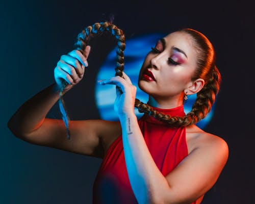 A woman with long hair holding a piece of hair