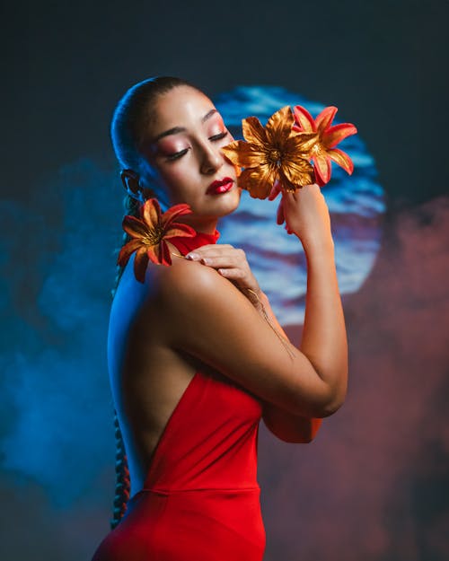 A woman in red dress holding flowers