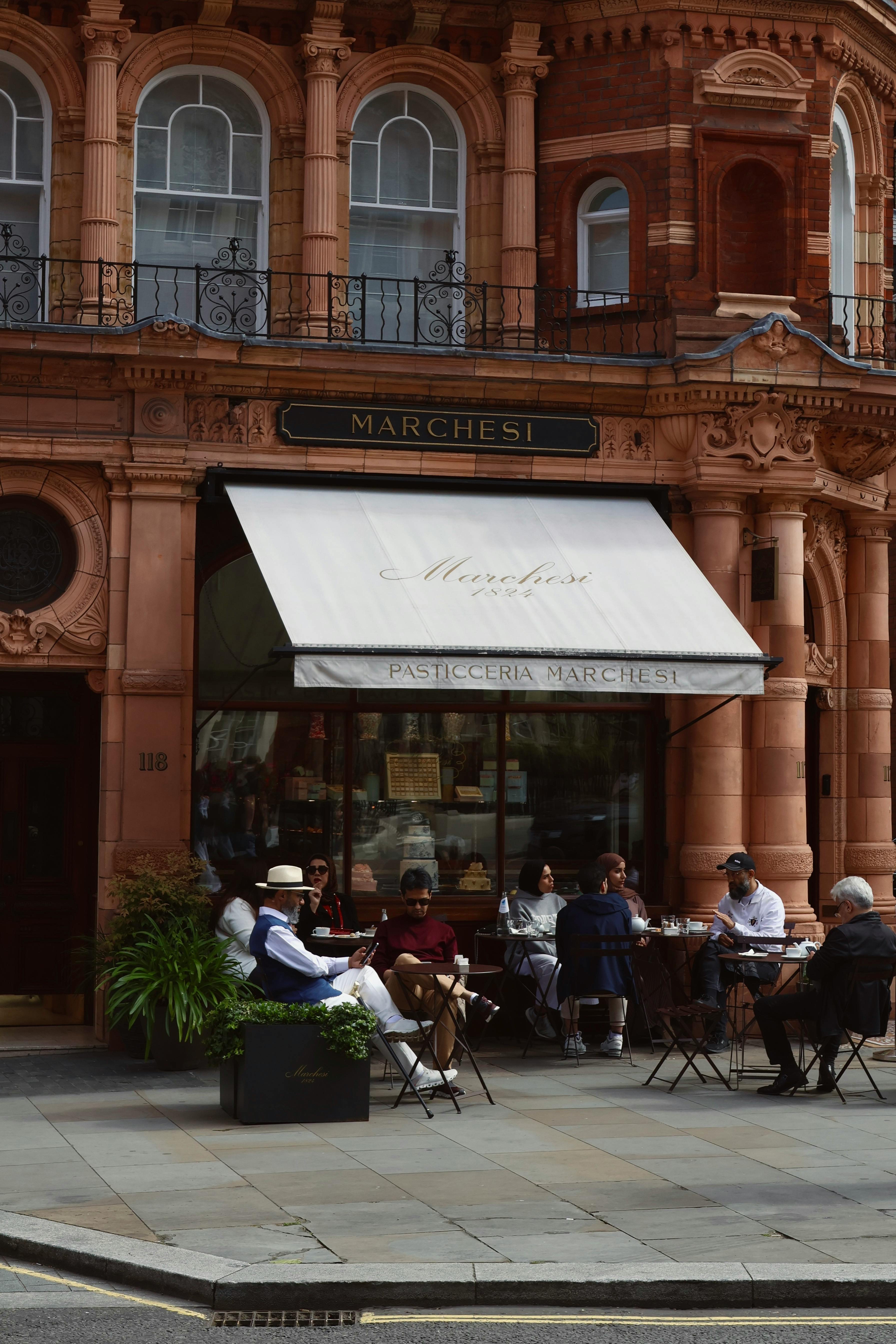 Elegant café with patrons enjoying outdoor seating in London, UK.