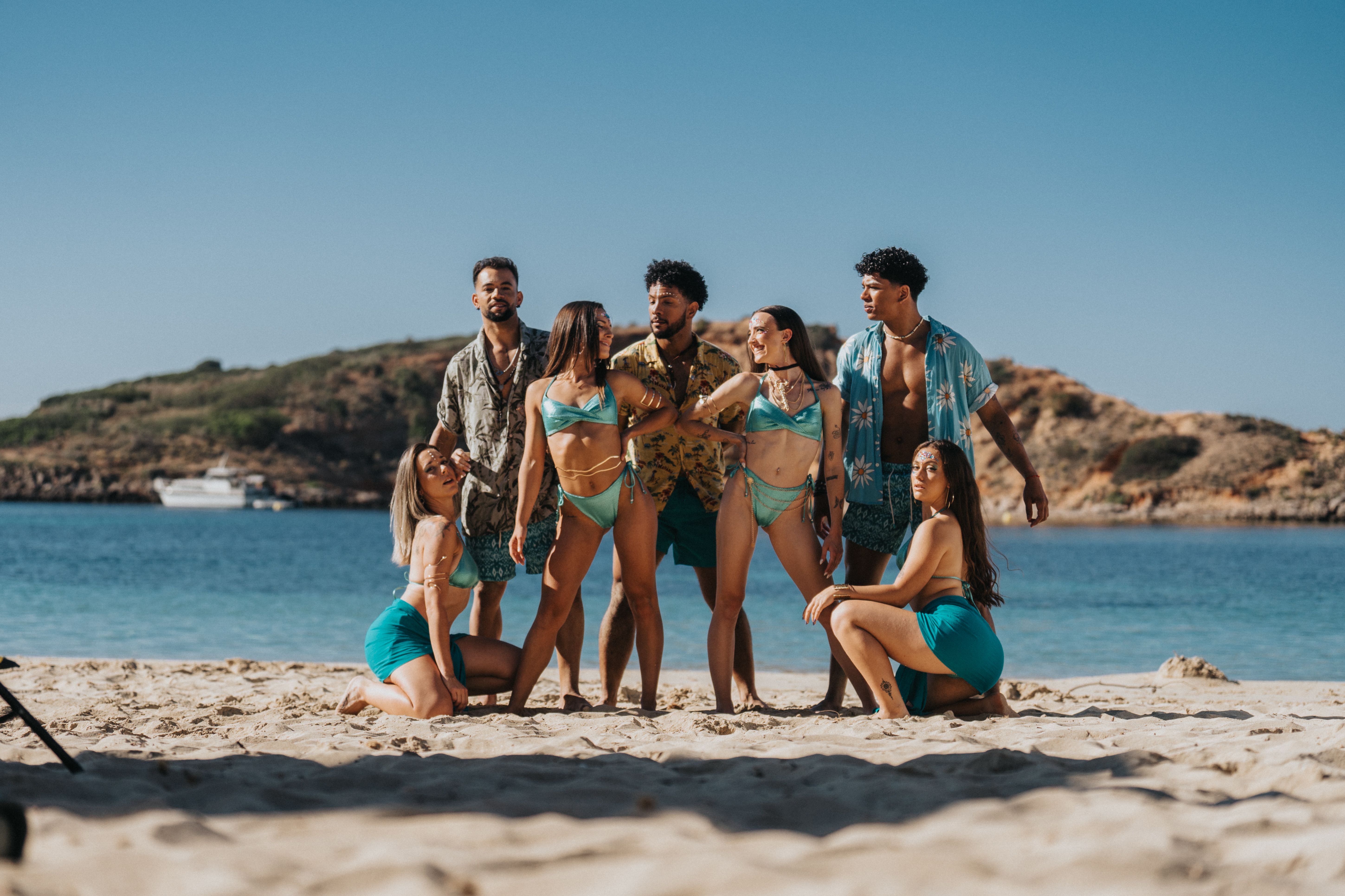 Fashionable group enjoying summer vibes in Palma, Spain on a sunny beach.