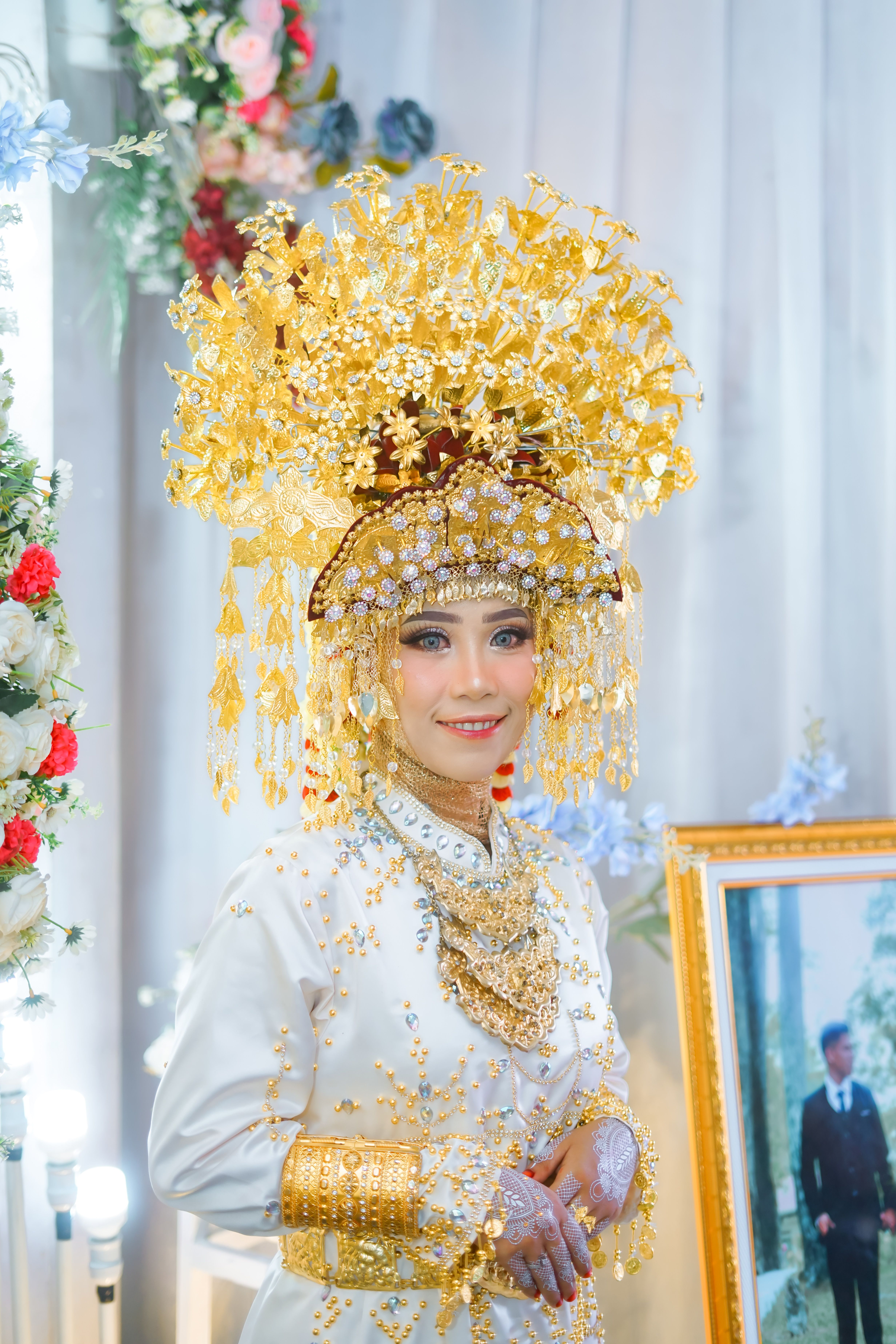 A bride in traditional attire with an ornate gold headdress, showcasing cultural richness.
