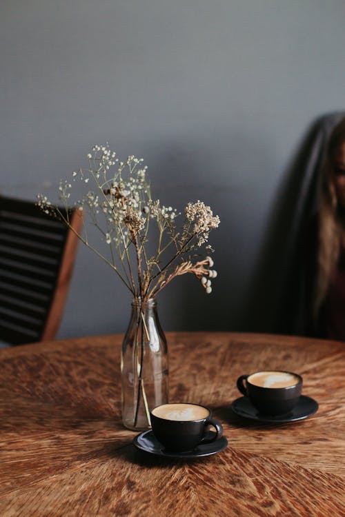 Free Photo Of Flower Vase Near Coffee Cups Stock Photo
