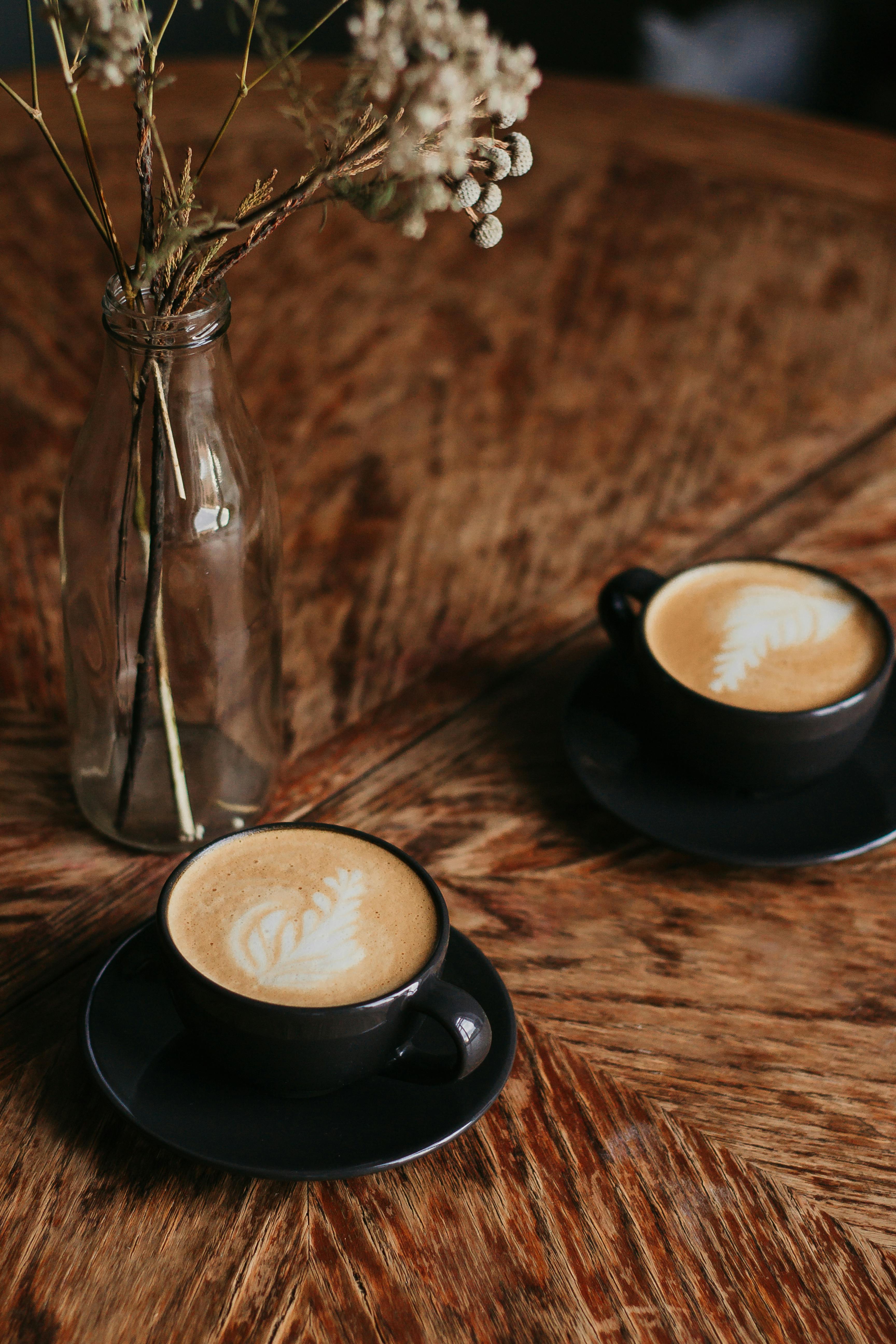 two cups of coffee on table