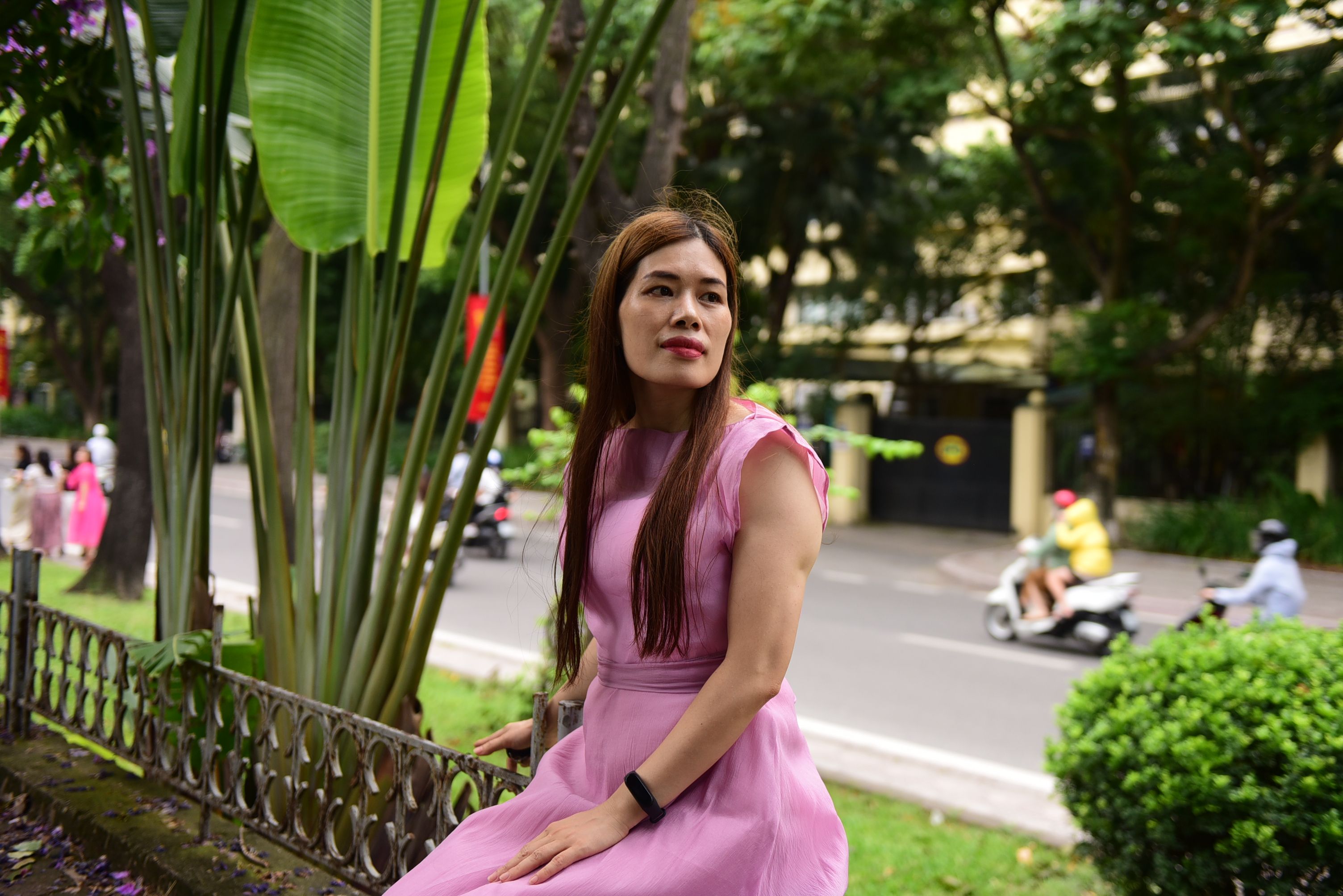 A woman in a pink dress sitting on a bench · Free Stock Photo