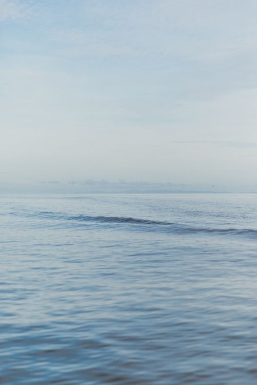 Free Tranquil ocean waves under a clear blue sky in Kereta, Waikato, New Zealand. Stock Photo