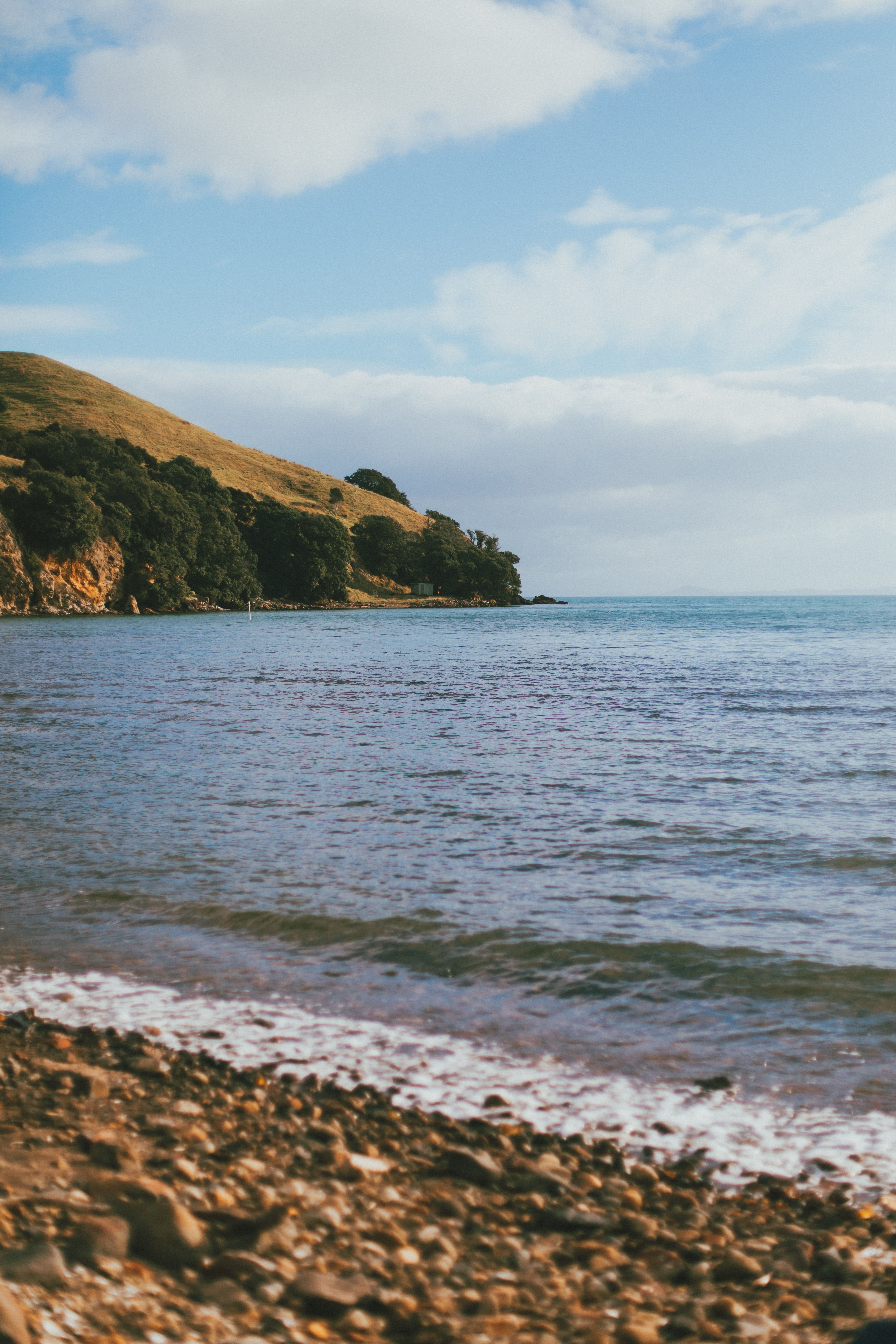 A beach with a blue sky and water · Free Stock Photo