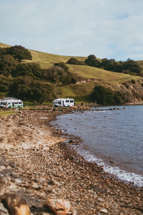 Free Explore serene camping on Coromandel's rocky shores, captured in natural beauty. Stock Photo