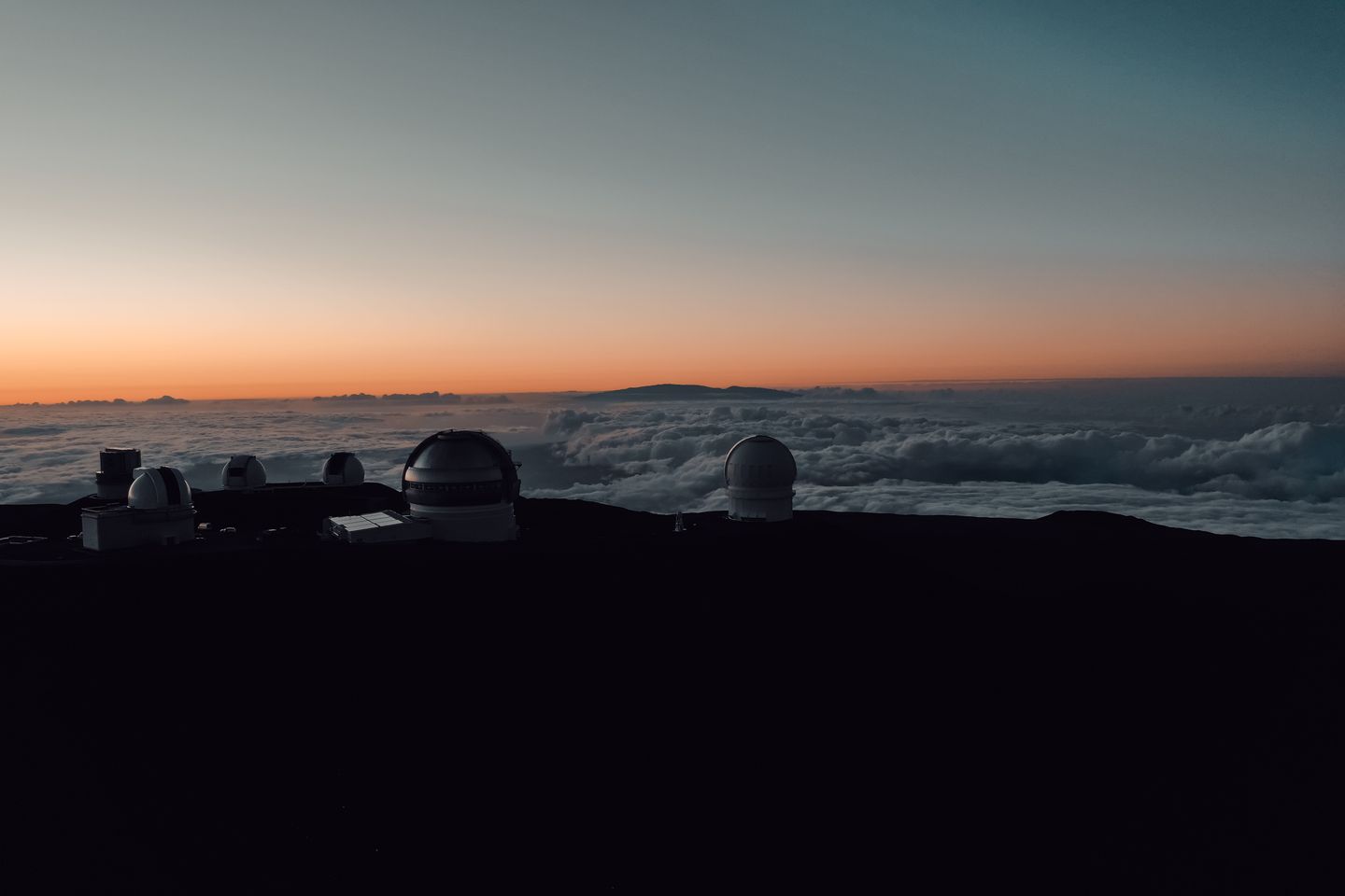 Observatories on the summit of Mauna Kea above a sea of cloud