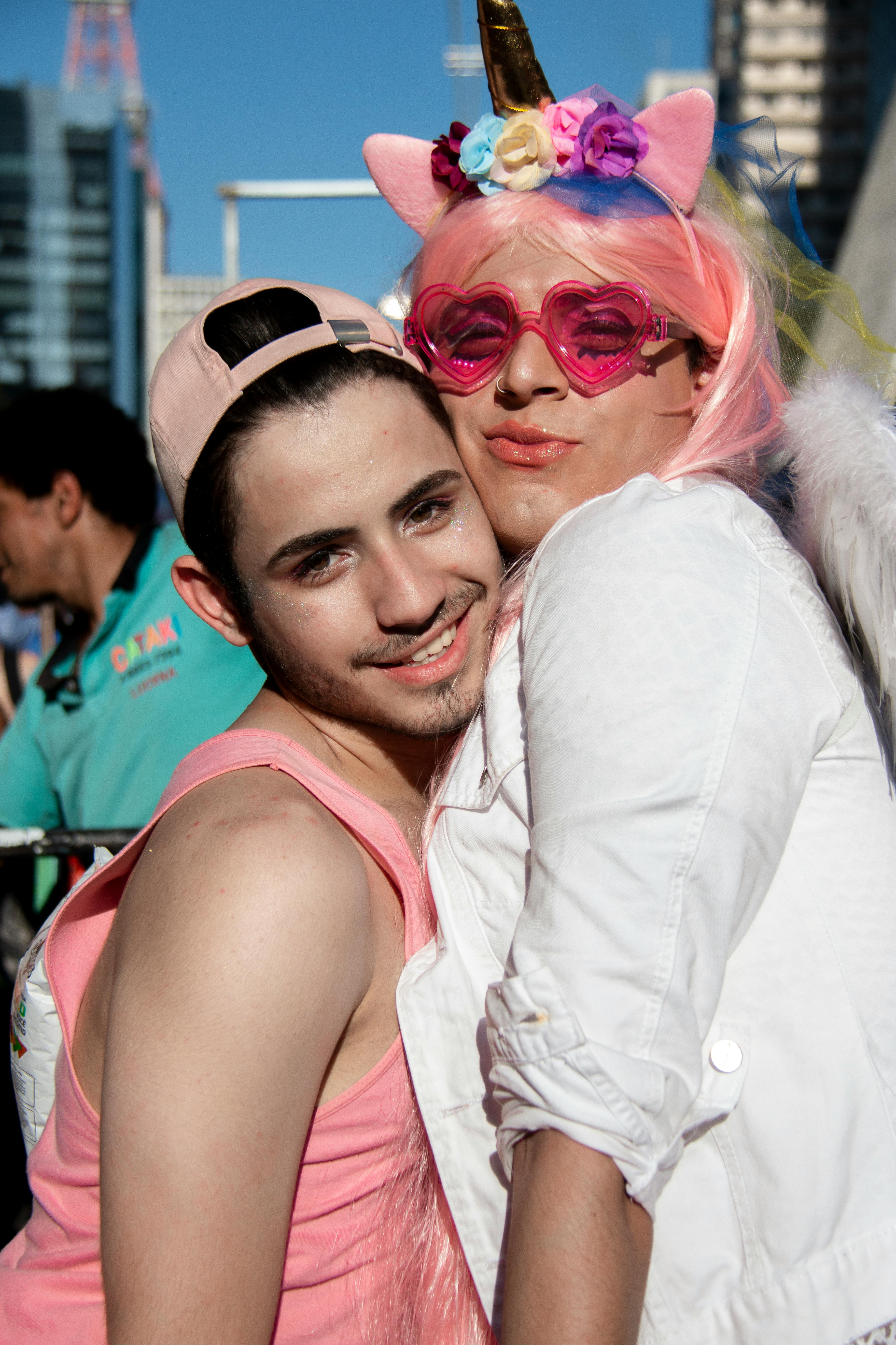 Two people dressed in vibrant outfits celebrating LGBT pride in São Paulo.