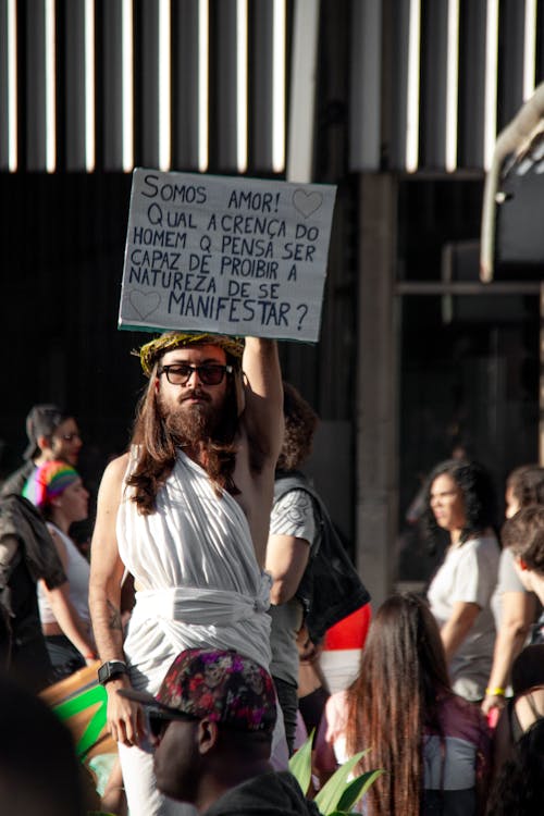 Free Man Raising White Signage Stock Photo