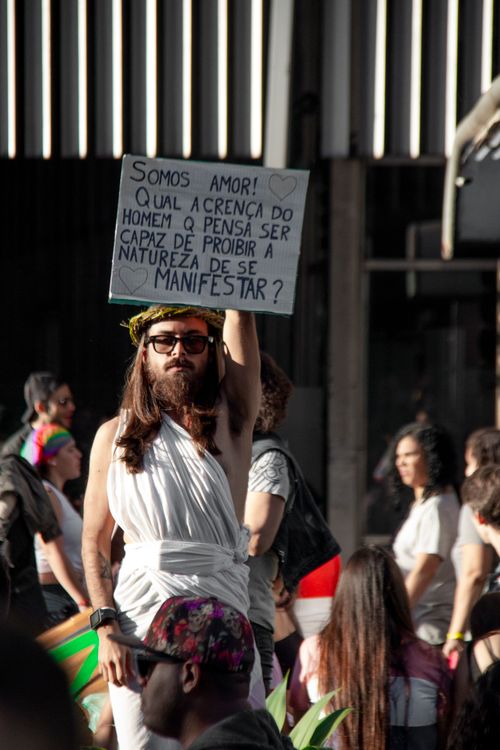 Free Lively LGBTQ parade in São Paulo, featuring colorful costumes and expressive signs. Stock Photo