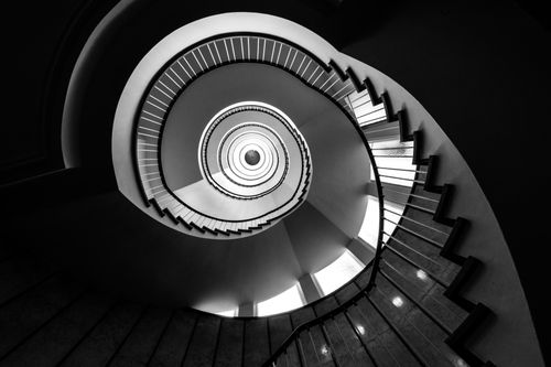 Free Dynamic black and white photo of a spiral staircase from a low angle, highlighting its architectural elegance. Stock Photo