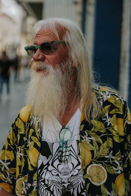 A man with long white hair and a beard wearing sunglasses